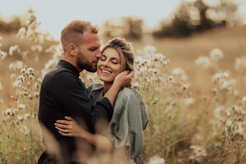 Young couple in love enjoying the beautiful nature. Intimate engagement session.