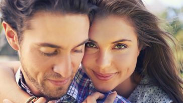 Closeup portrait of a young couple sharing a tender moment while enjoying a day outside