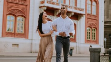 Handsome young multiethnic couple walking on the street