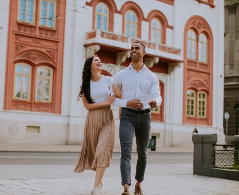 Handsome young multiethnic couple walking on the street