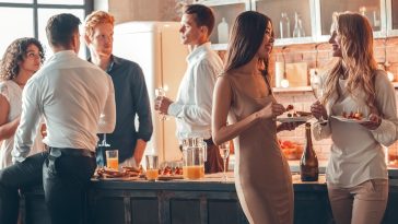 Group of men and women party together at home dinner