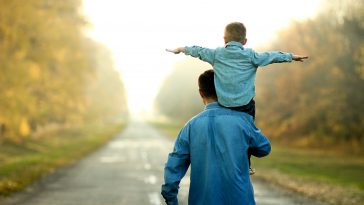 happy father and son walk in nature