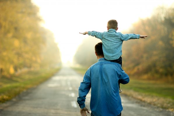 happy father and son walk in nature