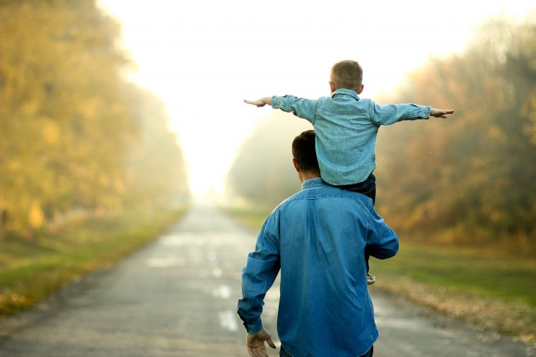 happy father and son walk in nature