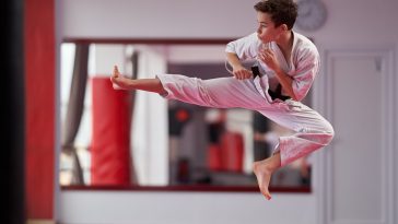 Young boy karate practitioner executing a kata