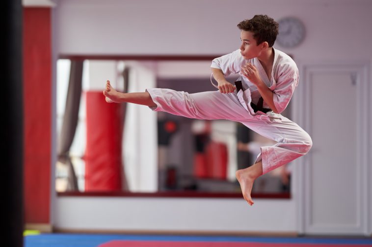 Young boy karate practitioner executing a kata