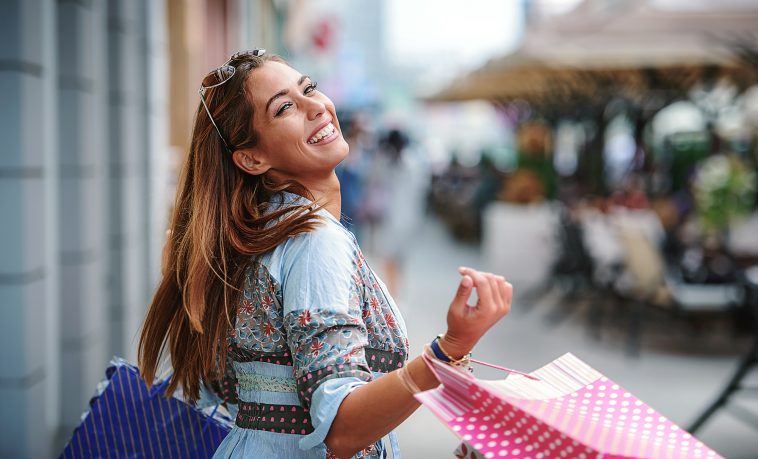 Attractive young woman enjoying in shopping. Consumerism, fashion, lifestyle concept