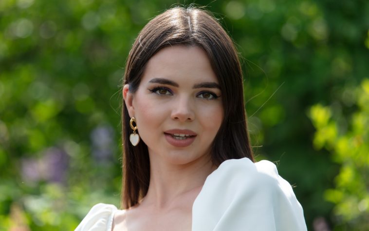 Portrait of a brunette girl outdoors in summer.