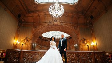 Magnificent wedding pair newlywed at rich wooden royal palace.