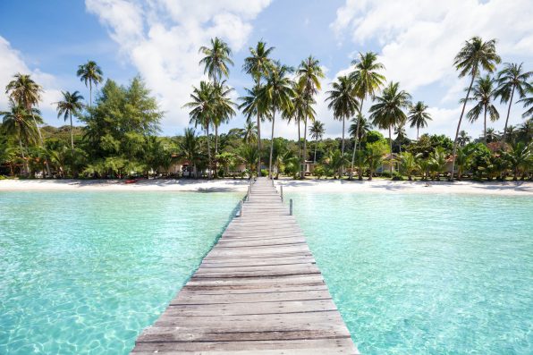 paradise beach with turquoise water, wooden pier and tropical palm trees, summer holidays in Thailand, Koh Kood