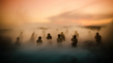 War Concept. Military silhouettes fighting scene on war fog sky background, World War Soldiers Silhouettes Below Cloudy Skyline At night. Attack scene. Armored vehicles. Tanks battle. Decoration