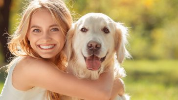 Young female blonde hair summer style concept with dog