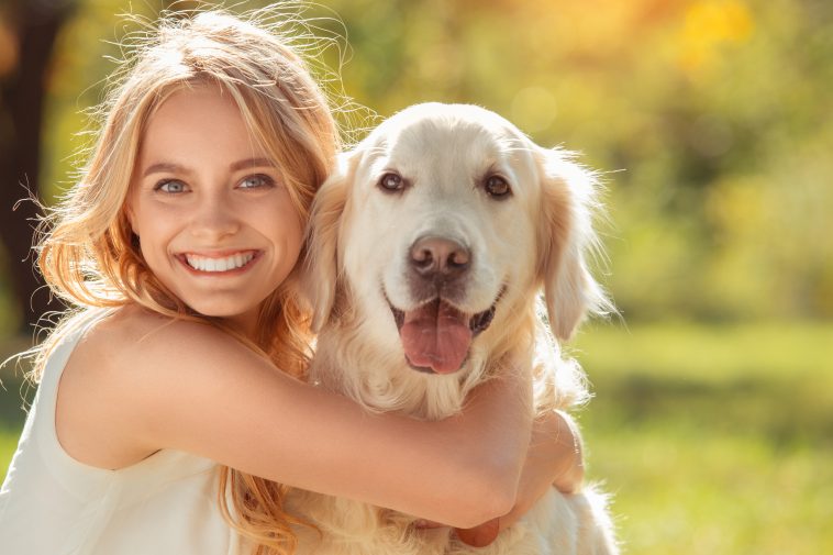 Young female blonde hair summer style concept with dog