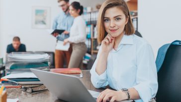 Young woman reading email at the office