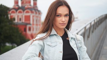 outdoors portrait of pretty woman wearing denim jacket.