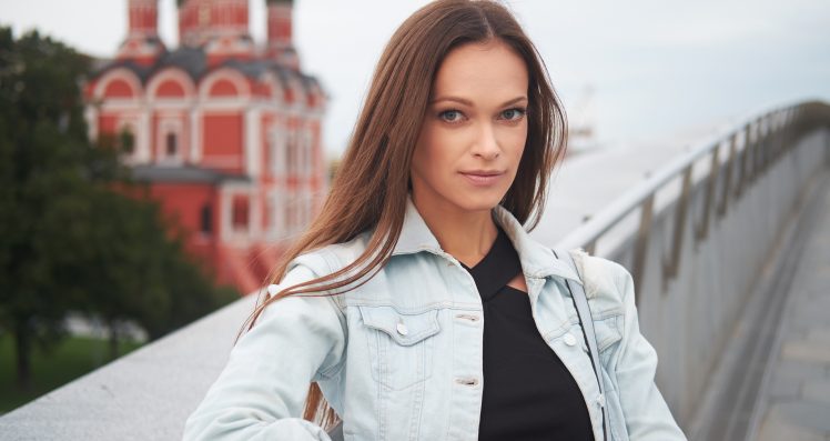 outdoors portrait of pretty woman wearing denim jacket.