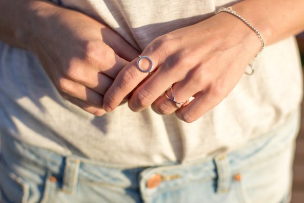 Female hand with silver jewelery, rings and bracelets minimalistic style.