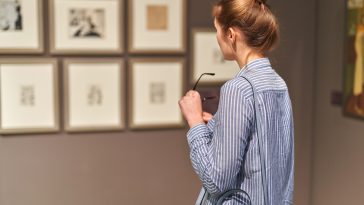 woman visitor in the historical museum looking at pictures