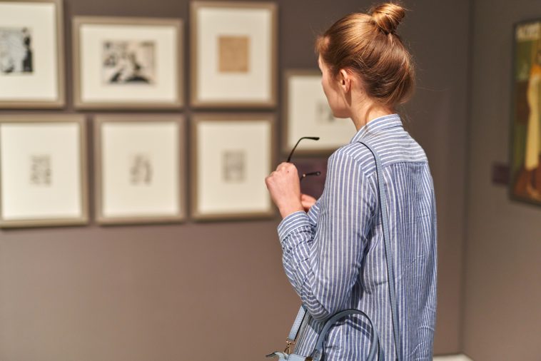 woman visitor in the historical museum looking at pictures