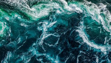 Abstract background. Waves of water of the river and the sea meet each other during high tide and low tide. Whirlpools of the maelstrom of Saltstraumen, Nordland, Norway