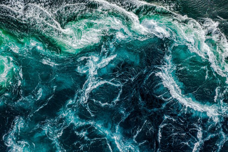 Abstract background. Waves of water of the river and the sea meet each other during high tide and low tide. Whirlpools of the maelstrom of Saltstraumen, Nordland, Norway