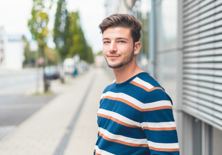 Portrait of young casual friendly man, selective focus, copy space