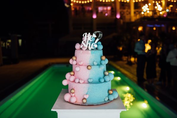 Big and delicious pink and blue baby gender reveal party cake.