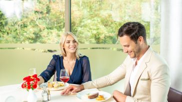 Attractive couple having lunch in hotel restaurant