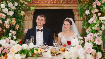 happy bride and groom at the table in the restaurant hall. festive banquet. tradition of celebrating marriage registration. wedding