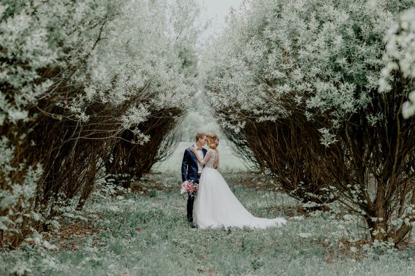 Wedding ceremony. Bride and groom alone in the shade of trees. A wedding in the summer.