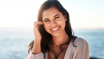 Portrait of a happy young woman enjoying a day at the beach.