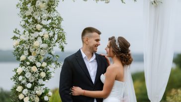 wedding ceremony of the newlyweds in a country cottage on a green hill