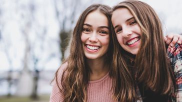 A Portrait of a teen girl with long hair in an urban