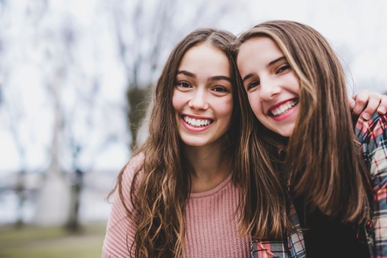 A Portrait of a teen girl with long hair in an urban