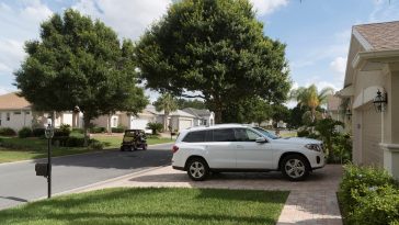 Luxury car parked on the driveway of a house in a Florida residential area, USA 2017