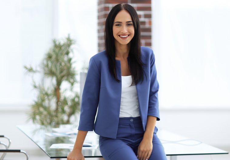 Young female businesswoman in the office near desk