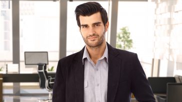 Portrait of goodlooking young businessman at office, smiling.