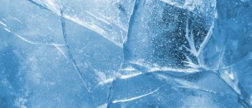 Abstract ice background. Blue background with cracks on the ice surface