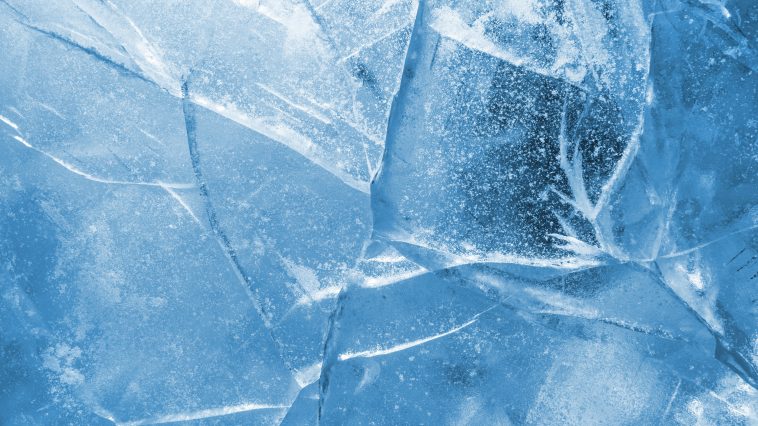 Abstract ice background. Blue background with cracks on the ice surface