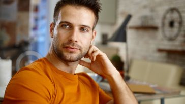 Closeup portrait of handsome young man, looking away.