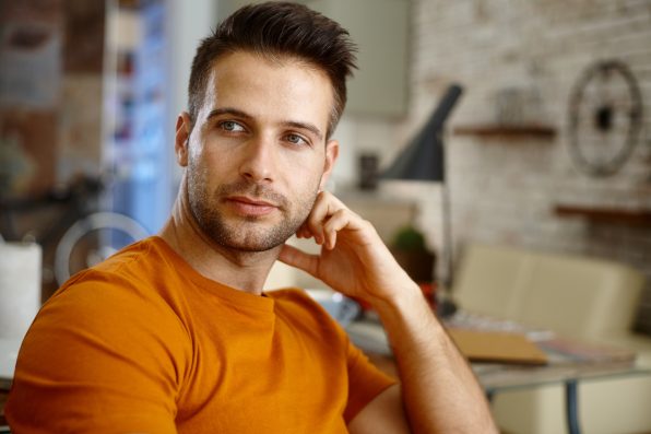 Closeup portrait of handsome young man, looking away.