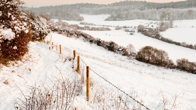 A view over some snow covered fields at dusk.  Taken on Pewley Down in Guildford, Surrey on a snowy December evening.