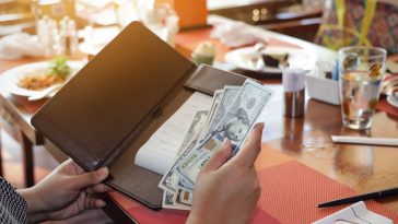 Close up of woman hand with a  Bill With American Dollars which people, payment and finances concept