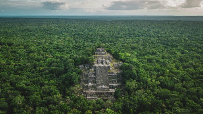 Aerial view of the pyramid, Calakmul, Campeche, Mexico. Ruins of the ancient Mayan city of Calakmul surrounded by the jungle