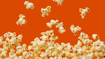 Close-Up Of Popcorn Against Orange Background