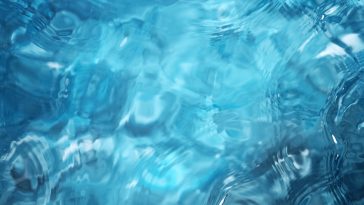 Blue water surface background, studio shot, texture of splashing abstract water shape