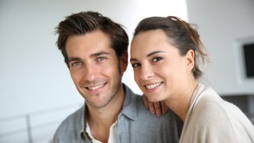 Portrait of smiling couple relaxing at home