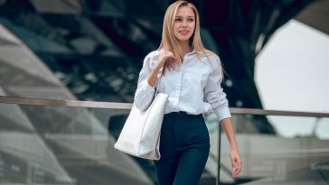 Elegance. Pretty elegant young business woman looking contented