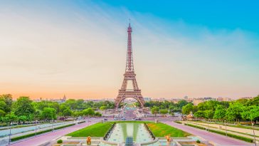 Paris Eiffel Tower and Trocadero garden at sunset in Paris, France. Eiffel Tower is one of the most famous landmarks of Paris., toned