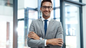 Crossed arms, smile and portrait of businessman in office with confidence for finance career. Happy, corporate and male financial specialist with pride for company revenue and wealth management